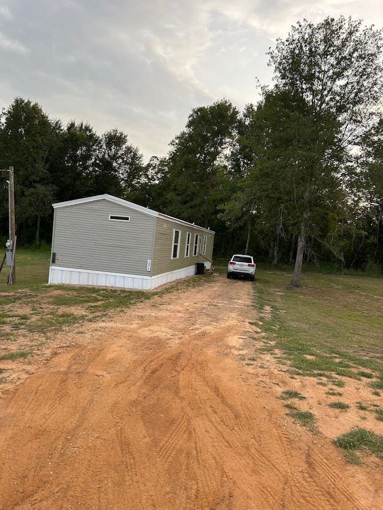 Brand-new sage green manufactured home for delivery to your own rural property